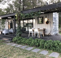 Absolute riverfront shipping container cabin - ACT Tourism